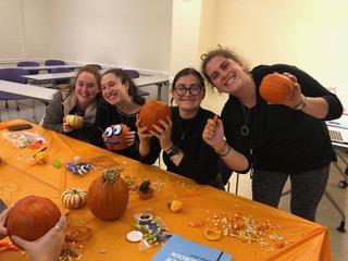 Left to Right: Hannah Reichelscheimer (Treasurer), Jessica Greenwald (Programming Chair), Rachel Anszelowicz (President), Randi Traison (Vice President) Not pictured: Paige Friedman (Outreach Chair). E-board members carving pumpkins at their latest event PUMP-kin spiced lattes, where they drank coffee, decorated insulin pump supplies, and carved pumpkins.