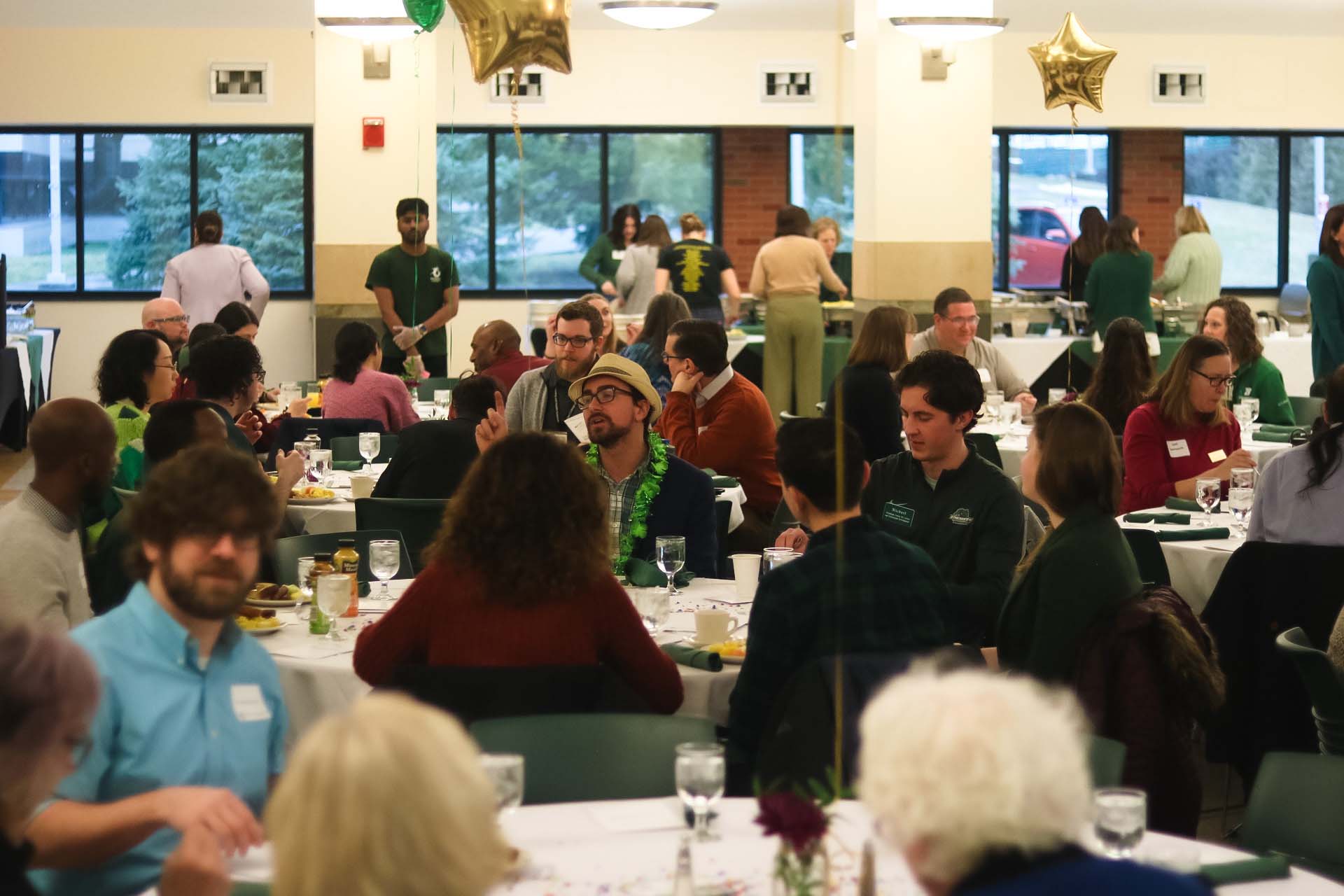 Faculty and guests sitting at tables at the Career Champions Breakfast