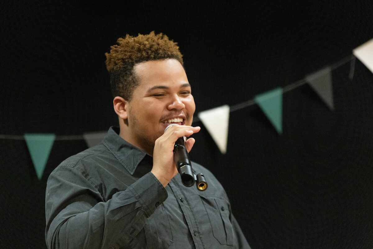 A male student at the microphone