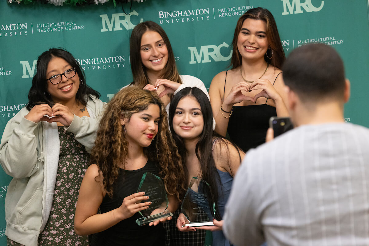 a group of female students against a University green backdrop.