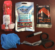 Contents of a Stop the Bleed kit, including trauma scissors, gloves, two tourniquets, and quickclot gauze