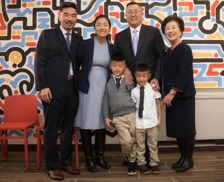 Charles M. Kim, right, with his wife, mother, brother and children.