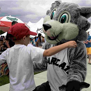 Baxter hugs a young visitor to the Binghamton campus