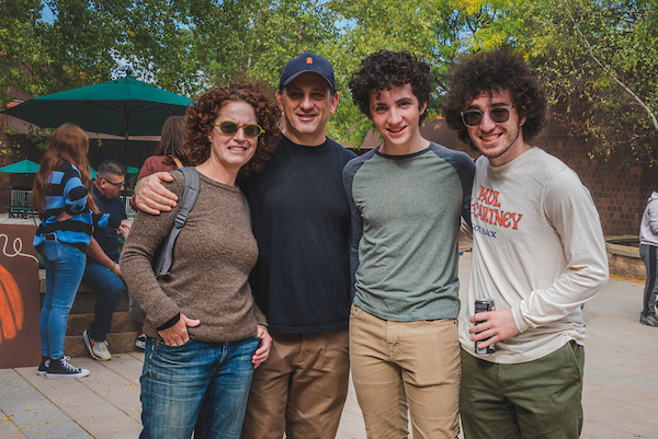 A family poses for a picture at the 2022 Fall Festival in College-in-the-Woods