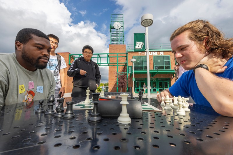 The treasurer of the chess club, Levi Axelrod, plays a friendly game of chess outside the Union