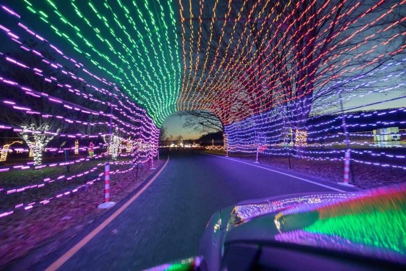 Car drives through a lighted display