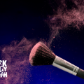 A close up image of a makeup brush with dark stylized background.