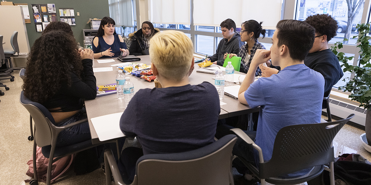 The Charlie K. Community Schools Room, at the University Downtown Center, Feb. 18, 2020. Pictured here is a Give Back Mentoring meeting, where CCPA Master of Social Work students Ariel Galvez, Zainab Jimoh and (not pictured) Indiara Jackson, work with area high school students.
