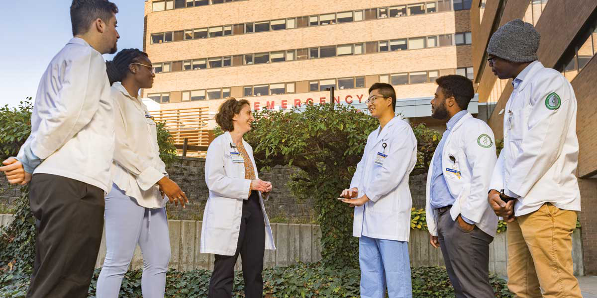 Karen Williams, center, director of the PGY1 pharmacy residency program at Guthrie Robert Packer Hospital, meets with students and residents, from left: Dominick Patafio; Oluwateniayo 