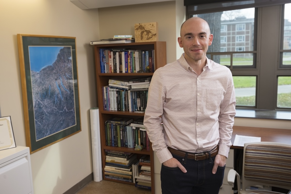 Associate Professor of Geography at Harpur College of Arts and Sciences Adam Mathews at his office in Old Johnson Hall.