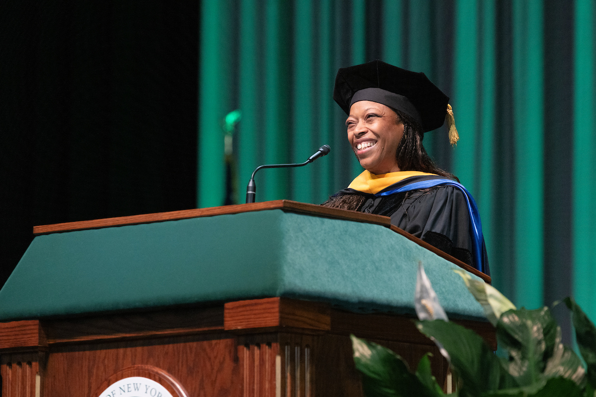Honorary degree recipient Yasmin L. Hurd ’82 speaks to graduates during the first Harpur Commencement ceremony of the day on May 11.