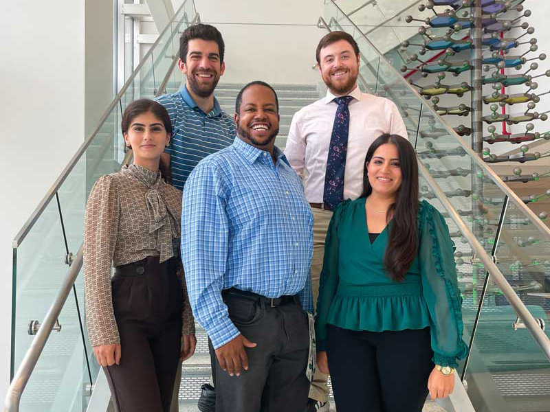 Tony Davis, assistant professor of pharmaceutical sciences, is surrounded by members of his capstone research group, all fourth-year students. Clockwise from left, Mana Halaji Dezfuli, Joseph D'Antonio, Eric Kelly and Juhi Gurtata.