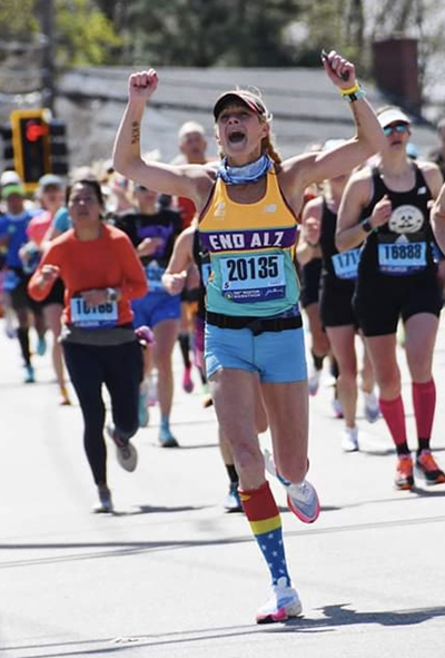 Christine Conti runs in the 2022 Boston Marathon for the Alzheimer's Association. She has run dozens of marathons and is a four-time IRONMAN.