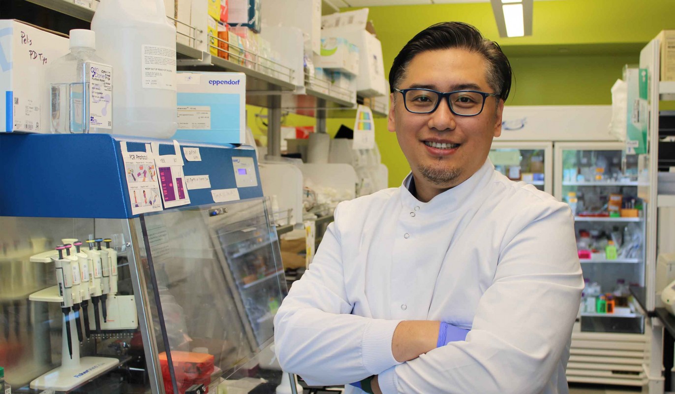 Assistant Professor of Pharmaceutical Sciences KC Mei standing in his lab at the School of Pharmacy.