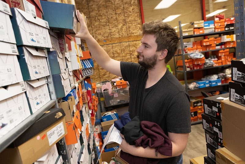 Tyler Lounsbery '23 finds a pair of sneakers while fulfilling an order at Locker Room 345.