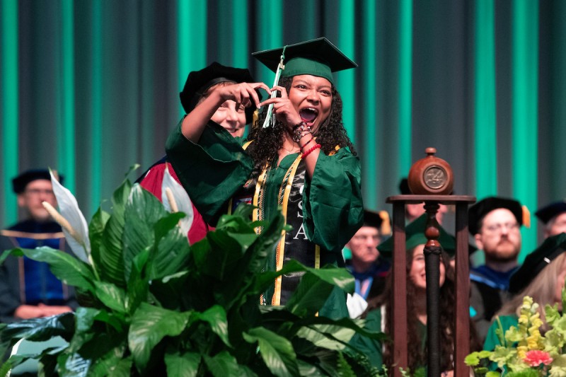 A Harpur graduate celebrates during the second Commencement ceremony on May 11.