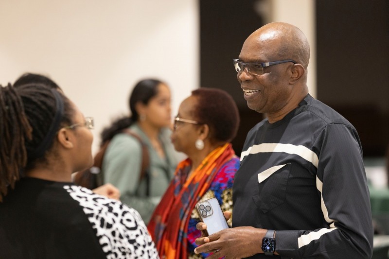 Collins Airhihenbuwa, a global public health scholar with more than 30 years in the field, chats with students during the kickoff of the Global Public Health program on Aug. 22, 2024, in Old Union hall.