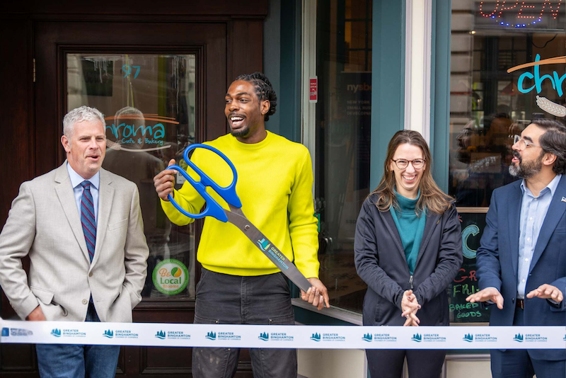 Leighton Blackwood '21 cuts the ribbon at the grand reopening of Chroma Café & Bakery in downtown Binghamton.