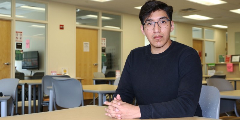 Alberto Torres sits in the EOP Tutorial Center, where he was first introduced to the idea of pursuing research in psychology.