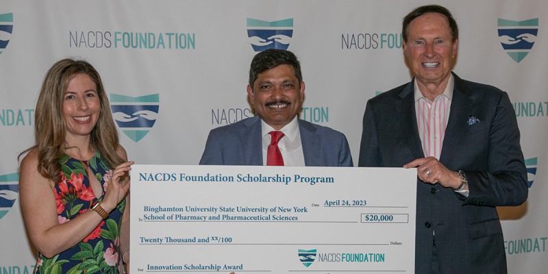 NACDS Foundation Chairman of the Board Steven C. Anderson, right, and NACDS Foundation President Sara Roszak present an innovation-focused award Kanneboyina Nagaraju, dean of Binghamton University's School of Pharmacy and Pharmaceutical Sciences.