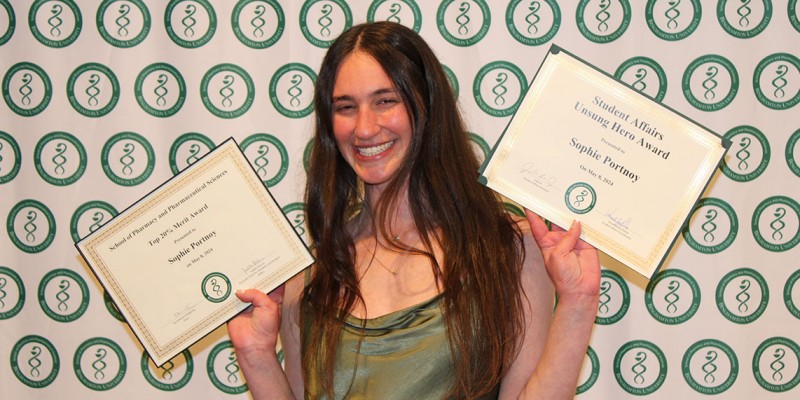 Sophie Portnoy, PharmD '24, shows off her Student Affairs Unsung Hero Award and Top 20% Merit Award