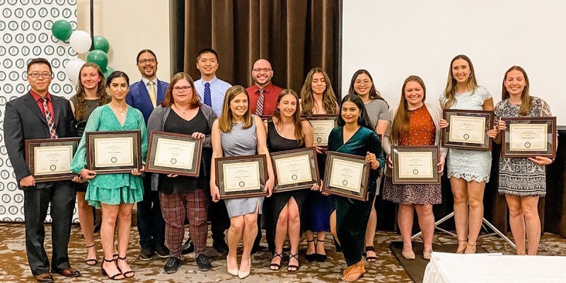 The top 20% of the School of Pharmacy and Pharmaceutical Sciences Class of 2022 pose after receiving their academic merit awards at the P4 Awards Ceremony in May.