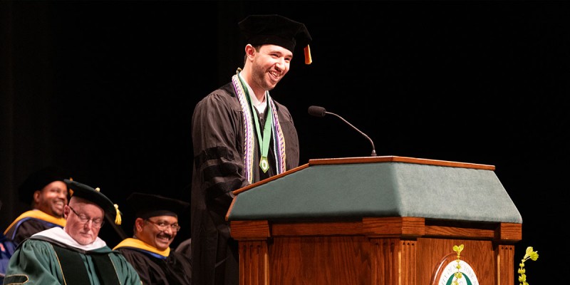 Class of 2024 graduate student speaker Paul Puccio addresses his classmates during the School of Pharmacy and Pharmaceutical Sciences Commencement ceremony.