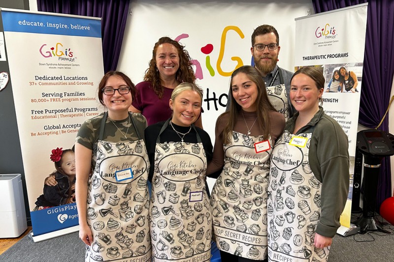 Binghamton University students Alessandra Antonacci, Madison Richards, Samantha Reiff, and Margaret Smith (front, left to right) developed the initial materials for the GiGi’s Kitchen-Language Chef program, working with Clinical Instructor Kara Nunn and Assistant Professor Cody Dew (back).