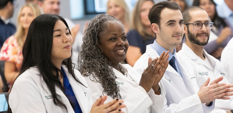 Iris Costner, second from left, is a graduate student in Decker College's first cohort of physical therapy students. She earned her white coat in May 2024; the cohort will graduate in 2026.