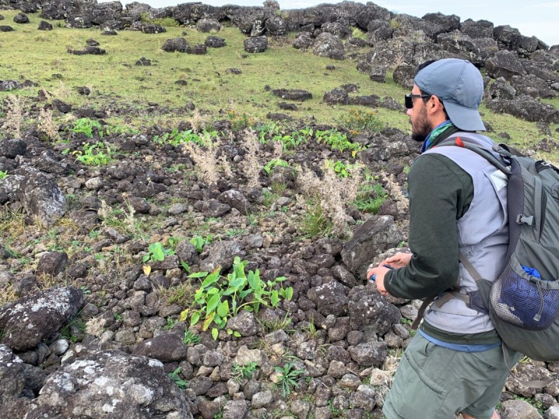 Binghamton University Environmental Studies Research Development Specialist Robert J. DiNapoli stands next to a rock garden on Rapa Nui, or Easter Island.