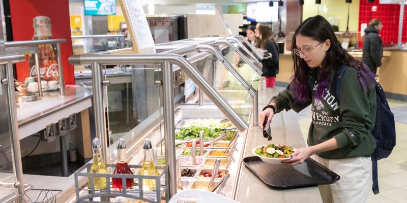 A student gets food at the Chenango Champlain Collegiate Center (C4) Dining Hall.