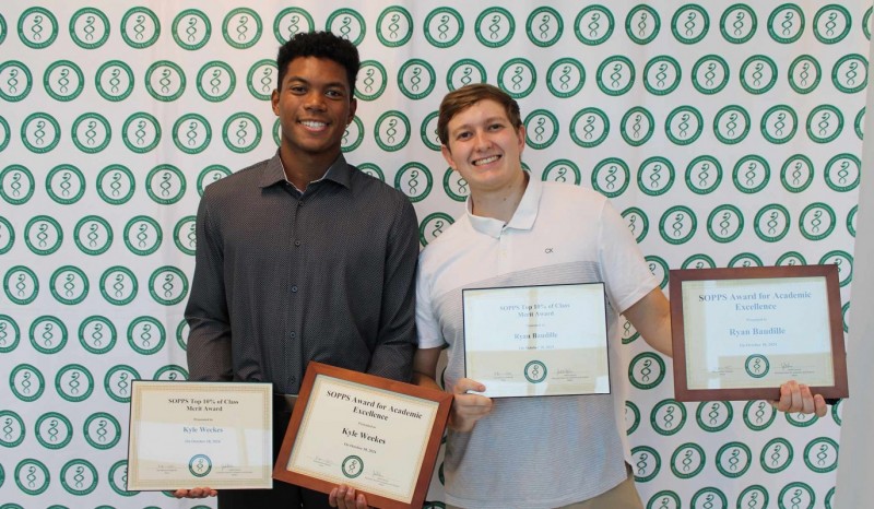 Second-year pharmacy students Kyle Weekes and Ryan Baudille pose together after receiving the Top 10% of Class Merit and Academic Excellence awards during the ceremony.