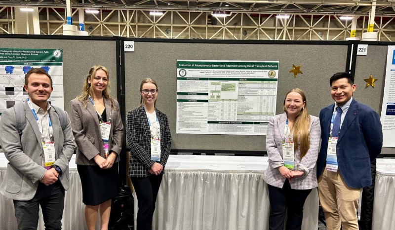 Clinical Assistant Professor of Pharmacy Practice Wes Kufel (left) standing with fourth-year PharmD students Calixta Terrell, Amanda Northup, Abigayle Carpenter and Manuel Sucuzhanay.