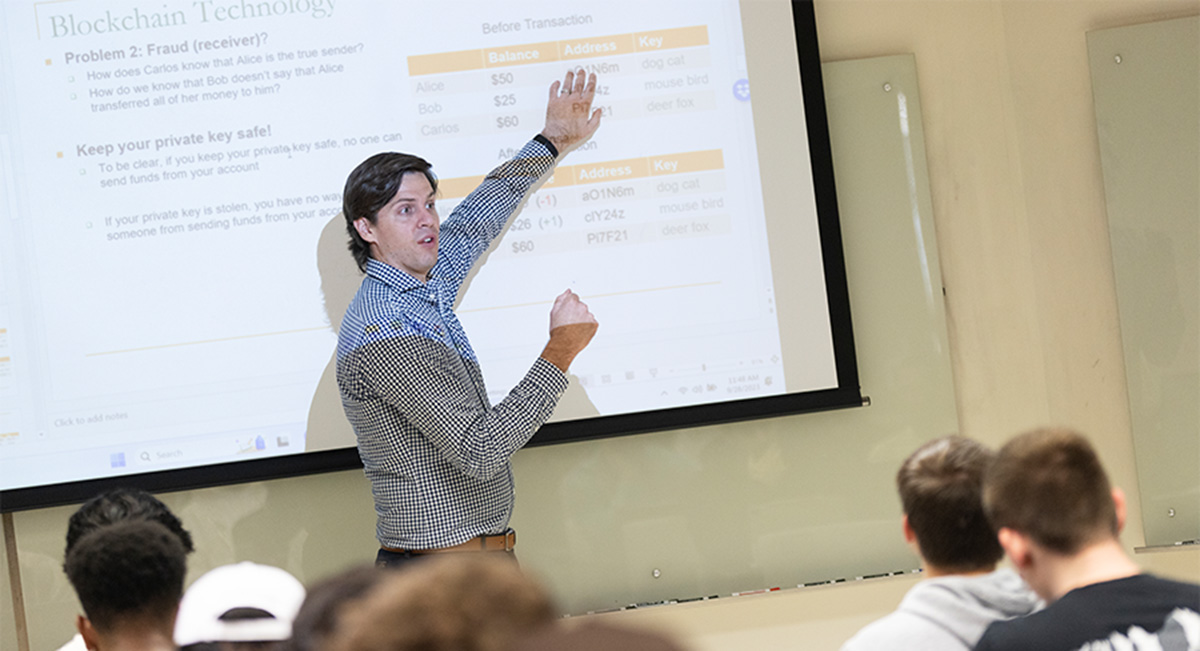 Binghamton University School of Management Assistant Professor Brad Cannon teaches a finance course in September 2023.